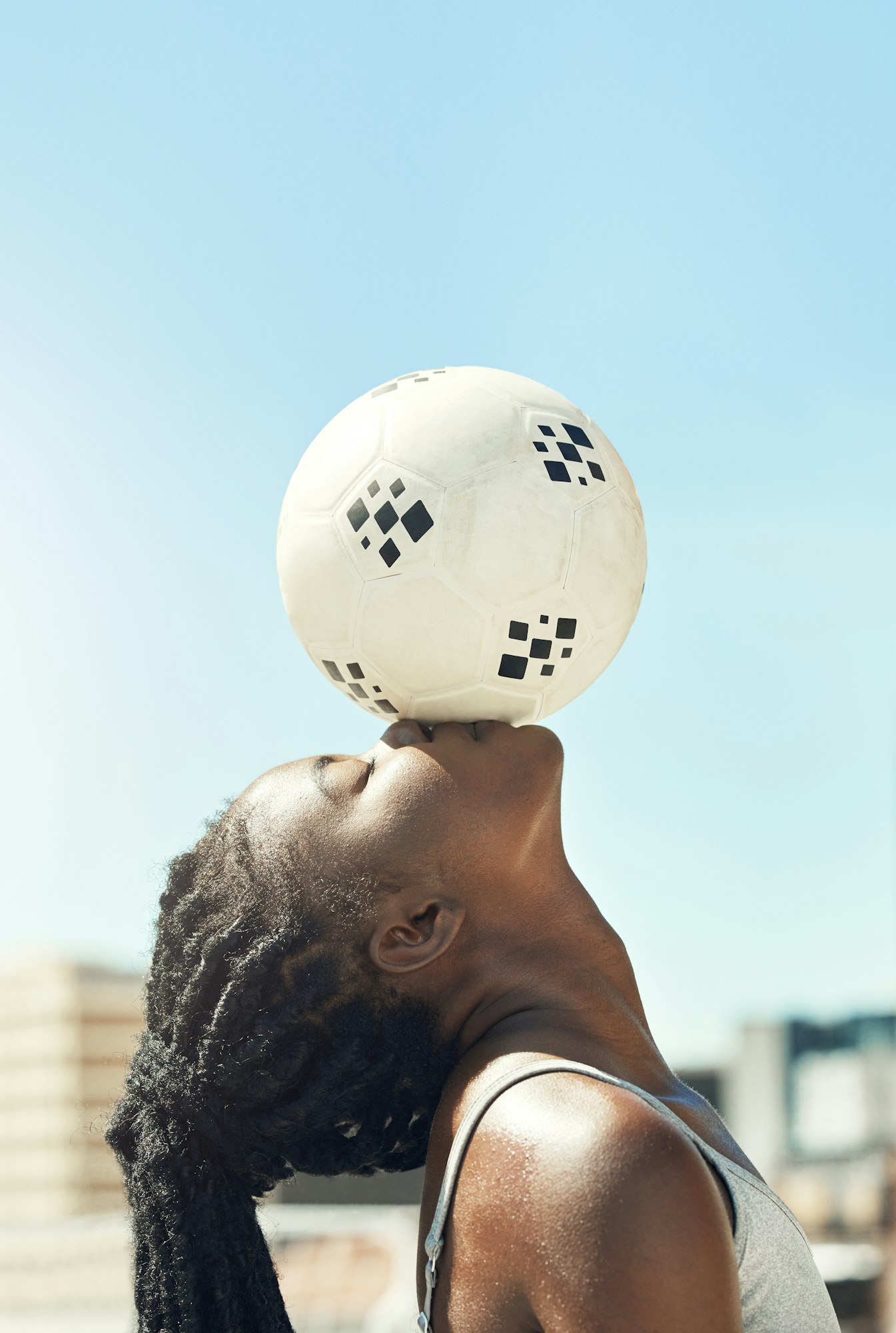 Soccer, ball and kiss of a black woman head with balance and fitness outdoor for sports. Football,